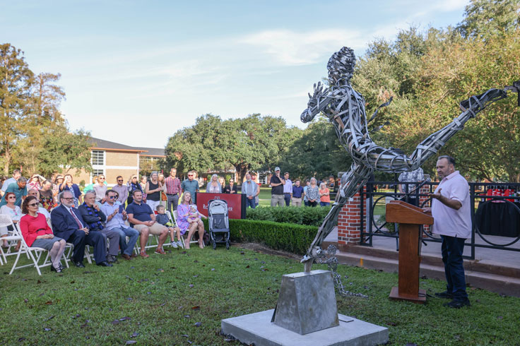 presentation outside by a statue